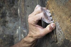 hand crimping hard on rock