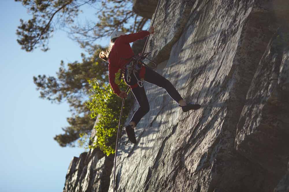 woman rappelling quickly