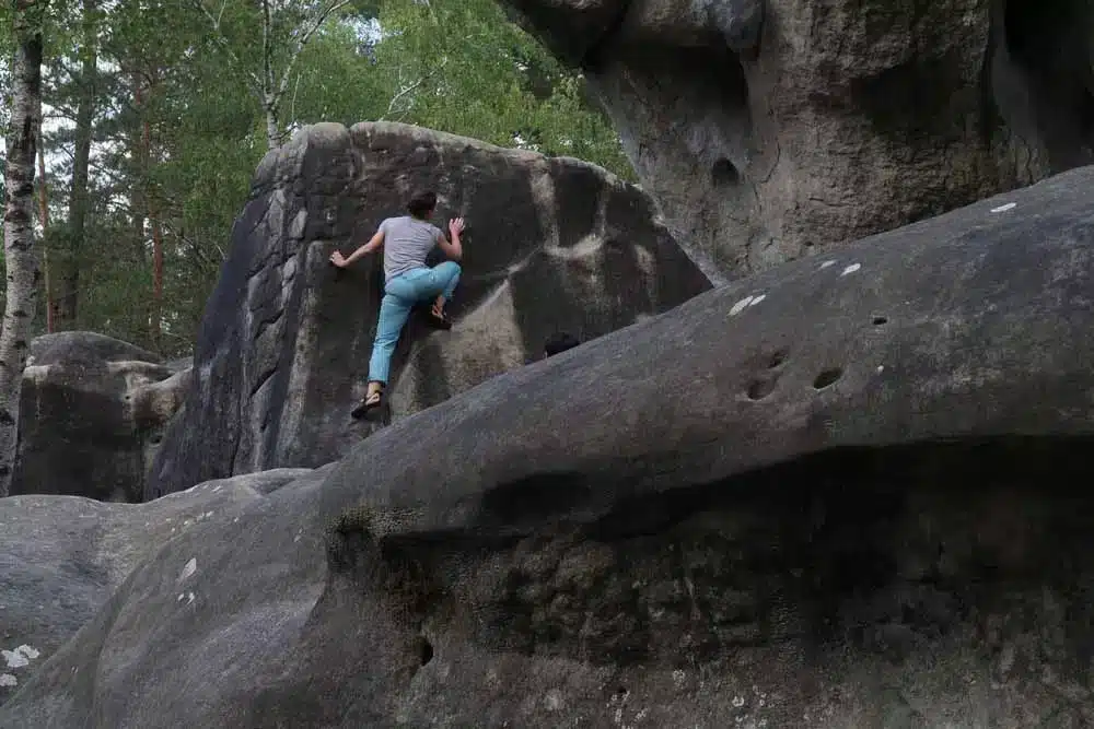 woman bouldering in fontainebleu