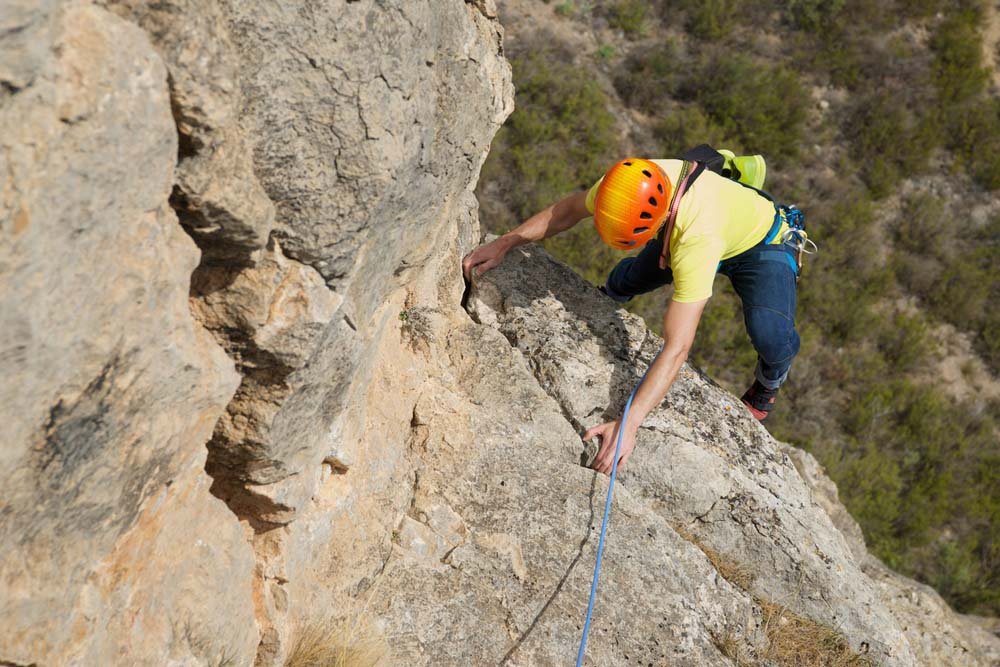 man seconding climbing route in costa blanca