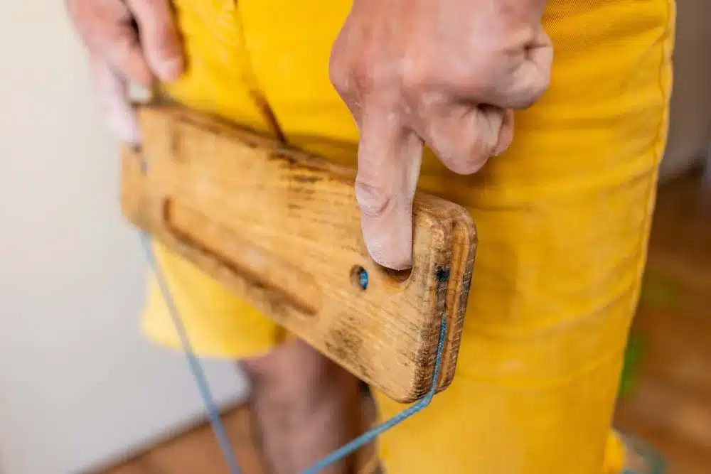 man using hangboard for finger strength training