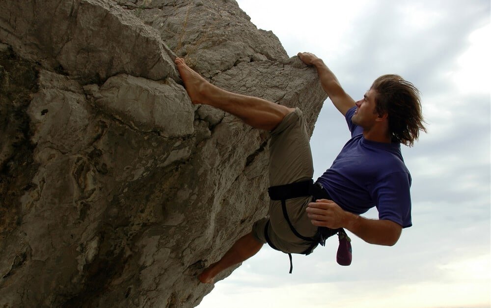 climber without shoes on rock edge