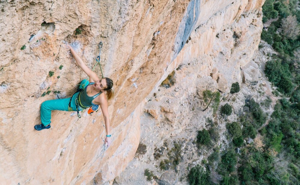 young woman climbing in spain