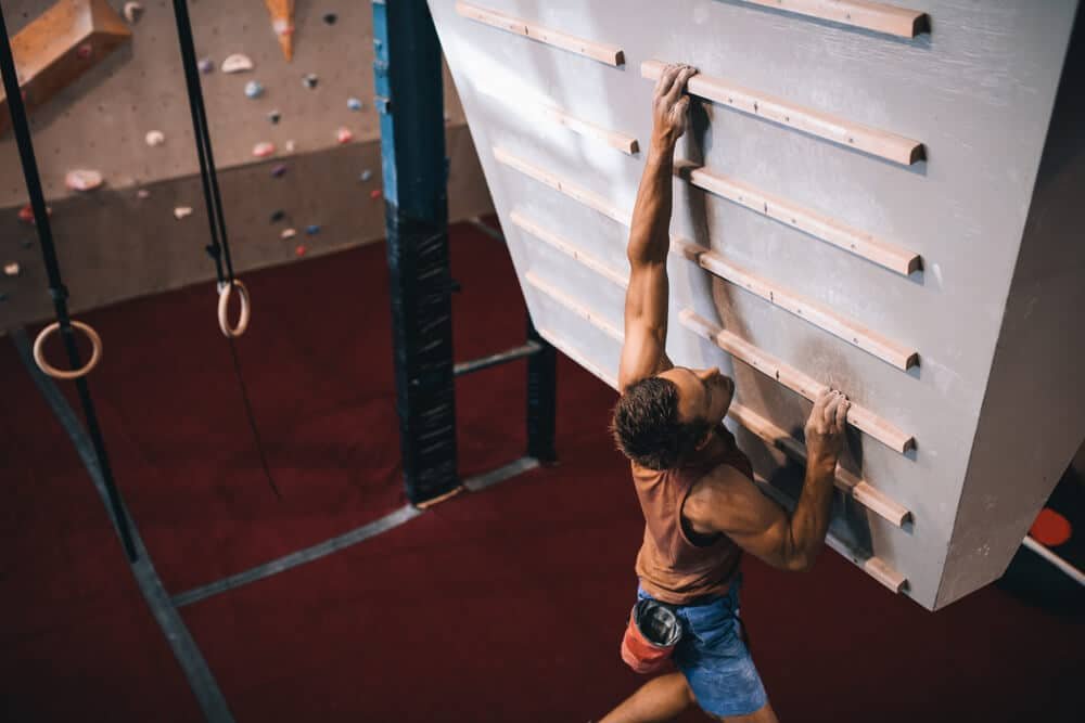 man using campus board