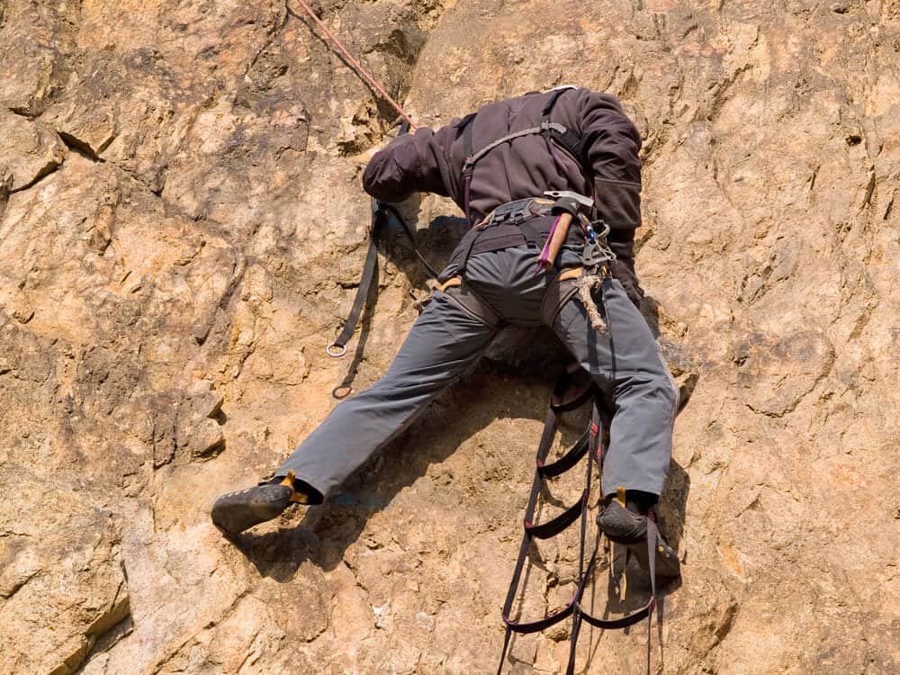 man aid climbing using ladders