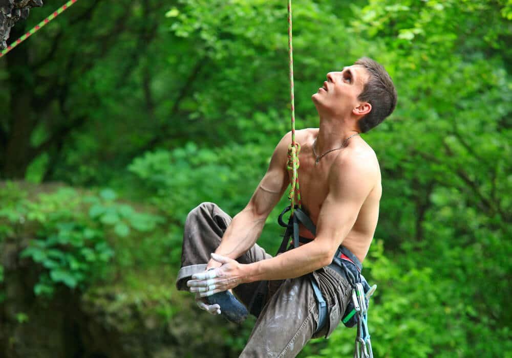 male climber rubbing foot