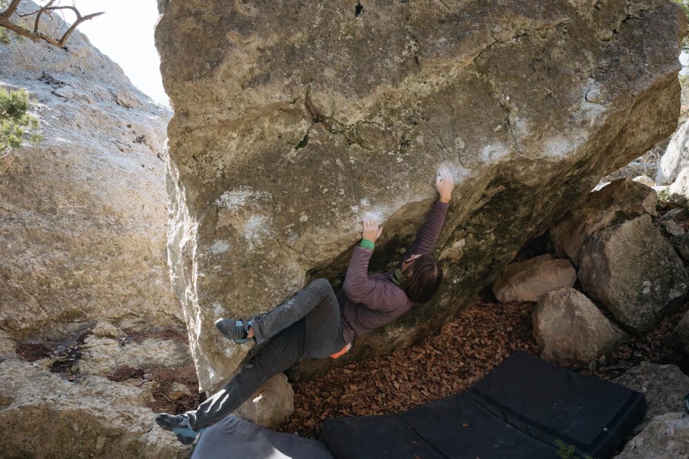 man low on boulder