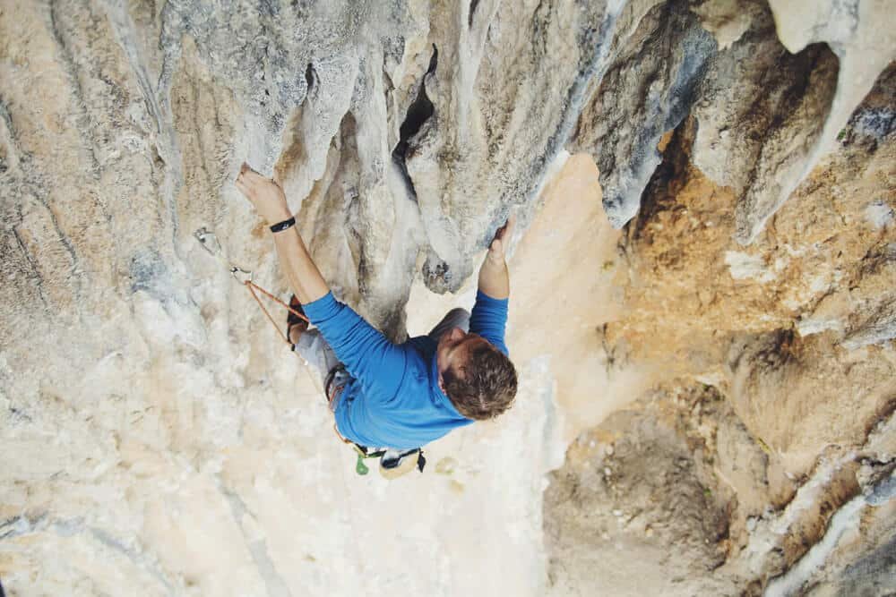 man climbing on overhanging tufas