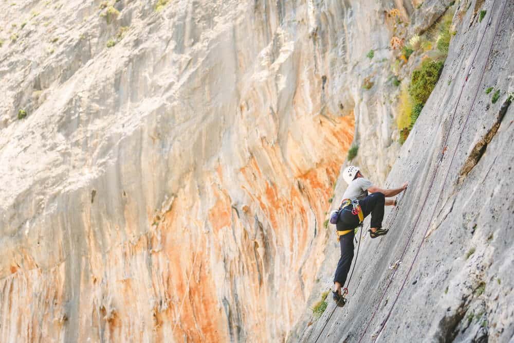 climber with helmet smearing on slab