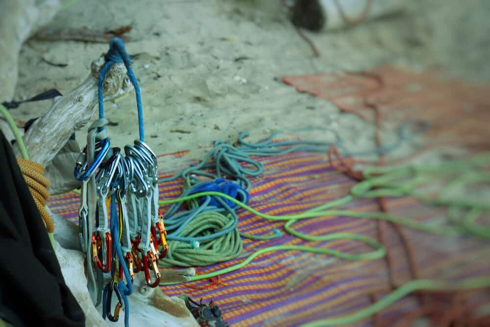 quickdraws hanging on stick with rope behind