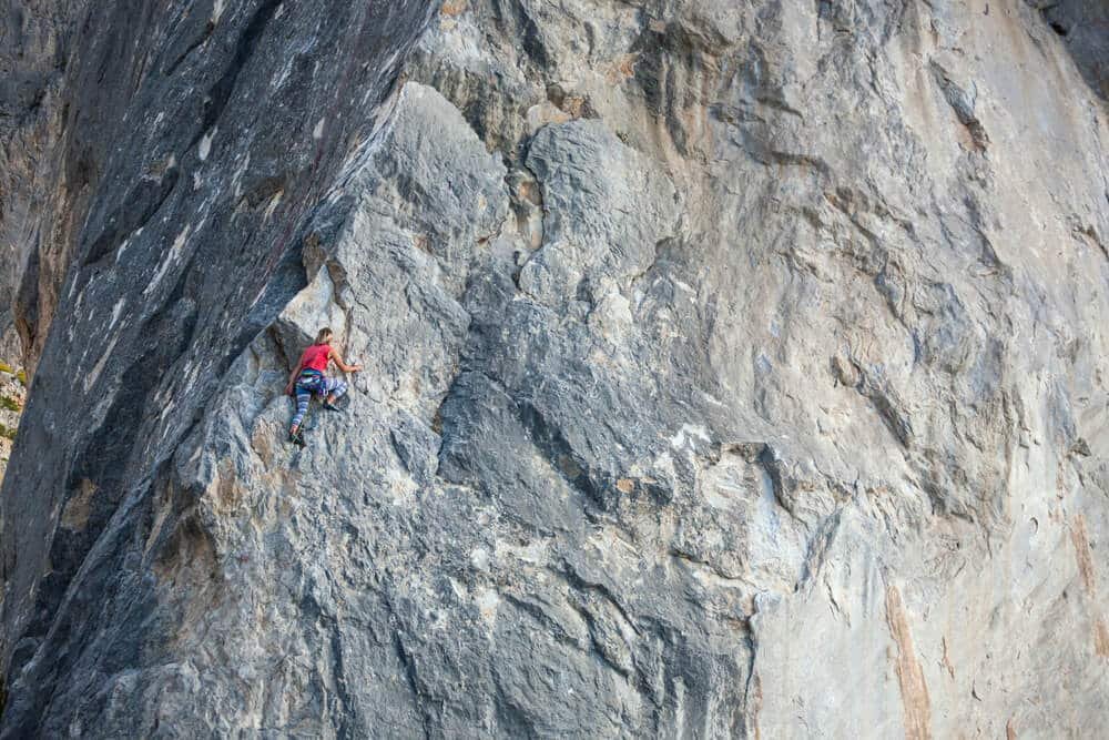 woman climbing arete