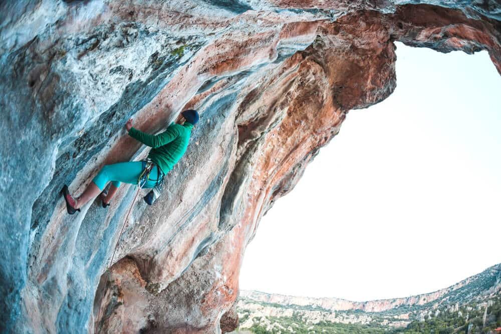 woman on steep wall smearing and reaching for hold