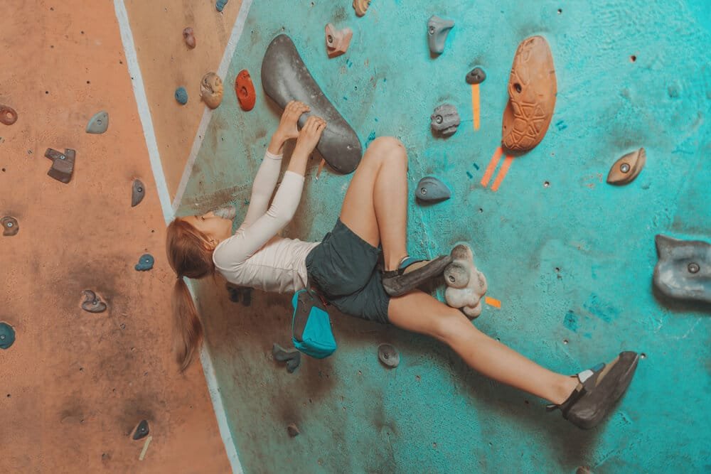 young child perform rear flag when climbing indoors