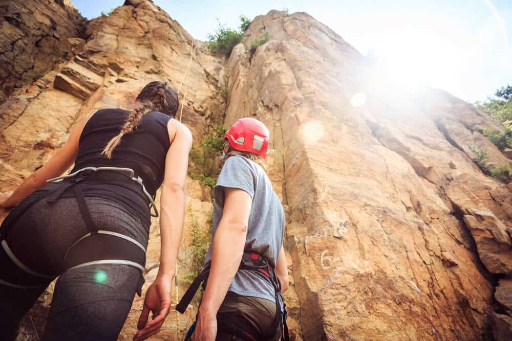 two young climbers look at cliff