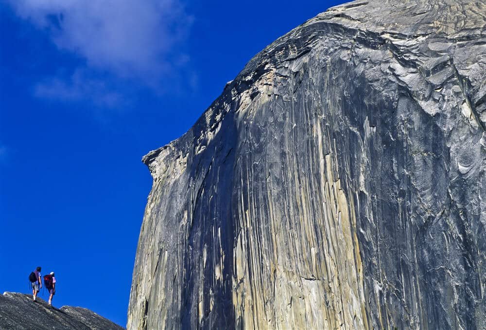 hikers look at half dome