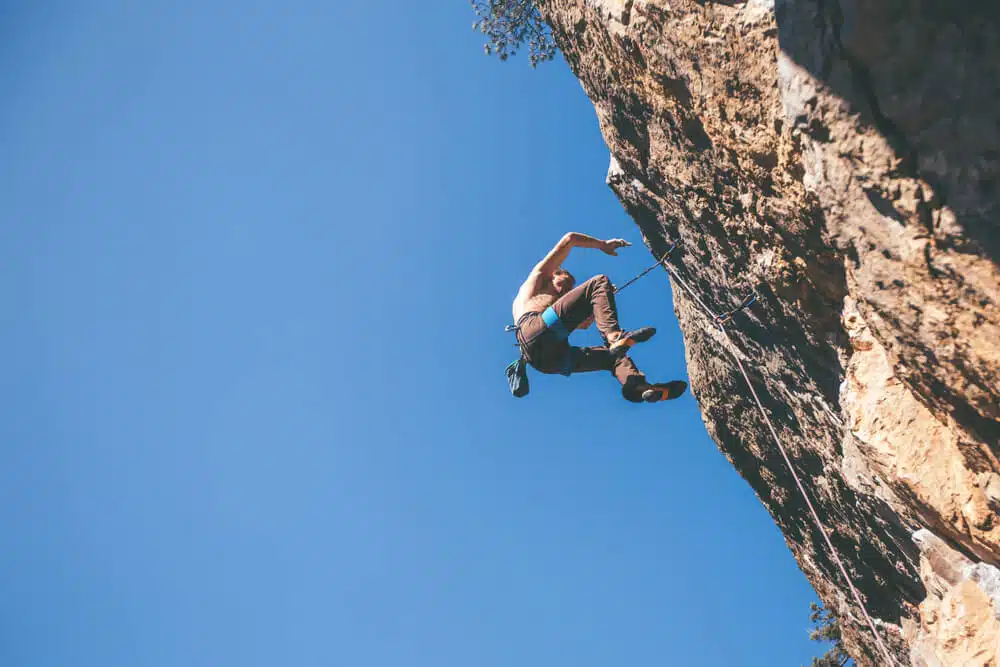 climber at the top of a cliff taking a fall