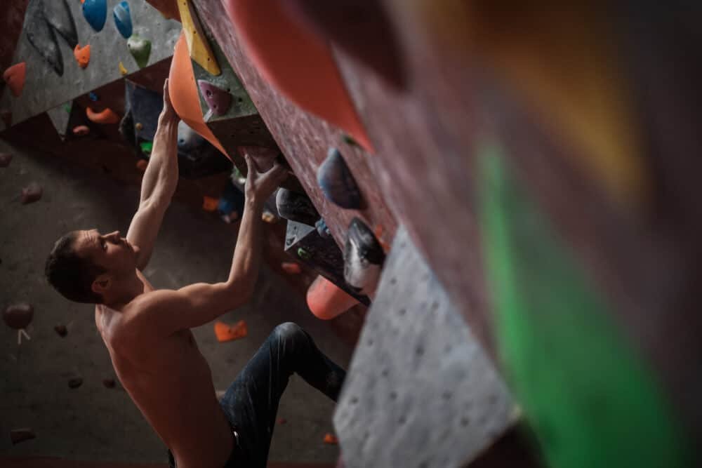 man preparing to dyno when bouldering