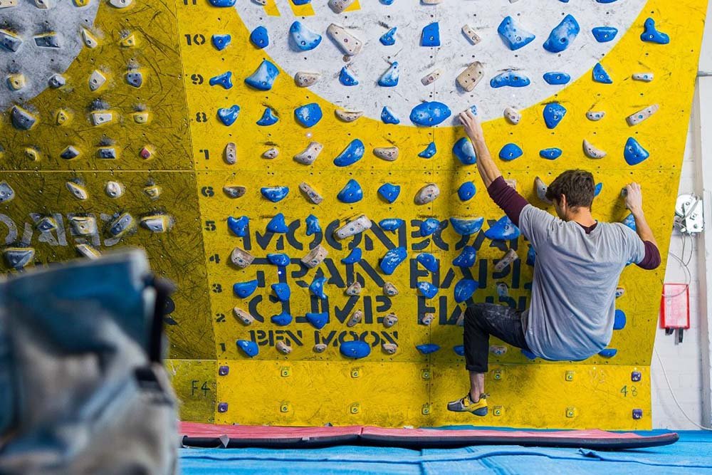 male climber using a moonboard to train