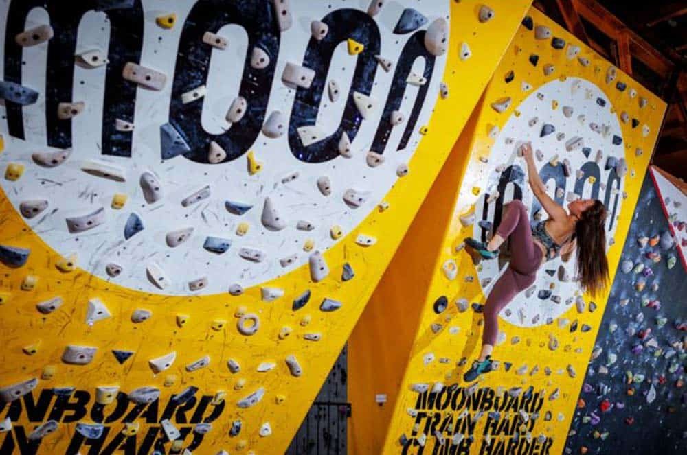 female climber using a moonboard