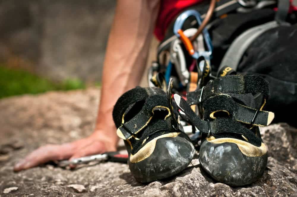 worn out pair of la sportiva miuras on the floor